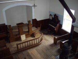 Interior of Tolson’s Chapel in 2012; the original “liquid slate” paint for a blackboard is visible to the left of the organ (Edie Wallace)